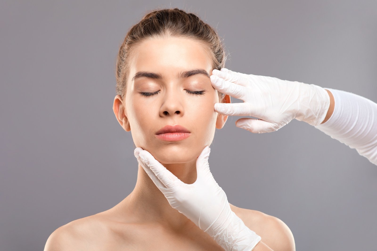 Attractive young woman getting treatment at beauty clinic
